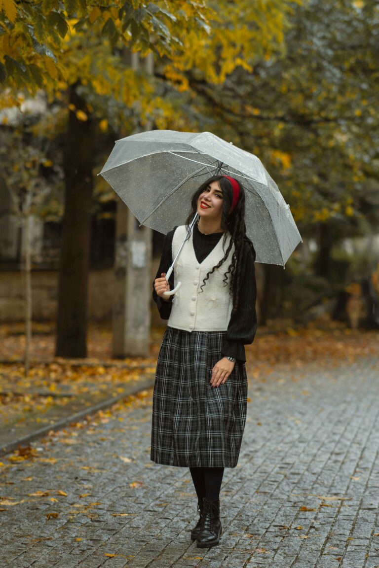 Woman dressed in a stylish rainy day outfit for cool summer weather.